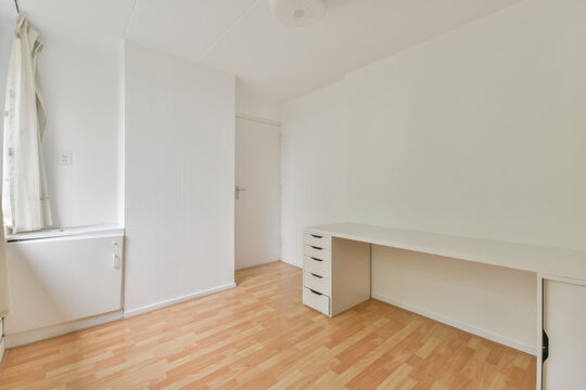 Small modern room with parquet floor and desk