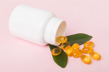Omega-3 capsules lie in white bottle on a table background. Fish oil tablets top view. Biologically active additives. omega 6, omega 9, vitamin A, E, vitamin D, vitamin D3, evening primrose oil