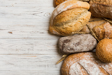 Homemade natural breads. Different kinds of fresh bread as background, top view with copy space