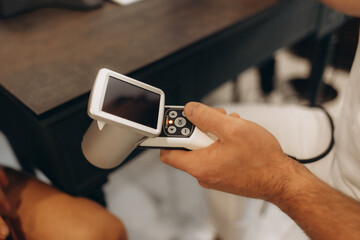 control of moles on the breast by a doctor wearing blue gloves on a female patient palpating the mole