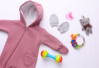 Set of newborn clothes, accessories and toys on a white background. Flat lay. Top view