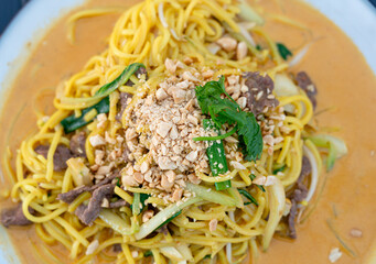 Chiang mai curry noodles, asian spicy egg pasta with meat, curried noodle soup Khao Soi or Khao Sawy, thai food