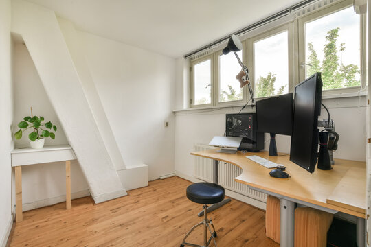 Bright home office with dual monitors and modern furniture