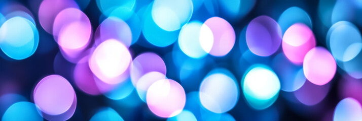 Abstract background with cool toned blur bokeh lights in shades of blue and purple fading into a soft haze 