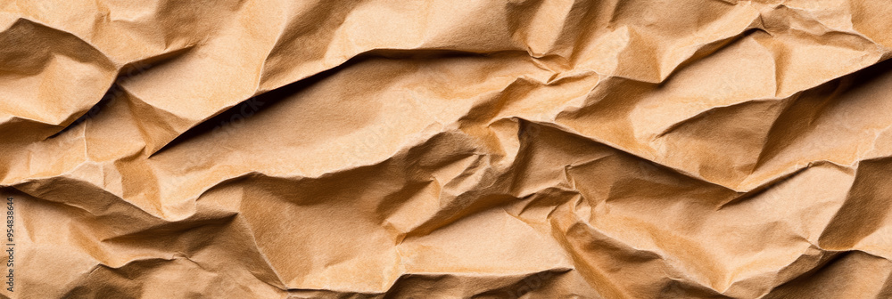 Poster crumpled recycled paper texture in natural brown tones with visible folds and shadows for a rustic f