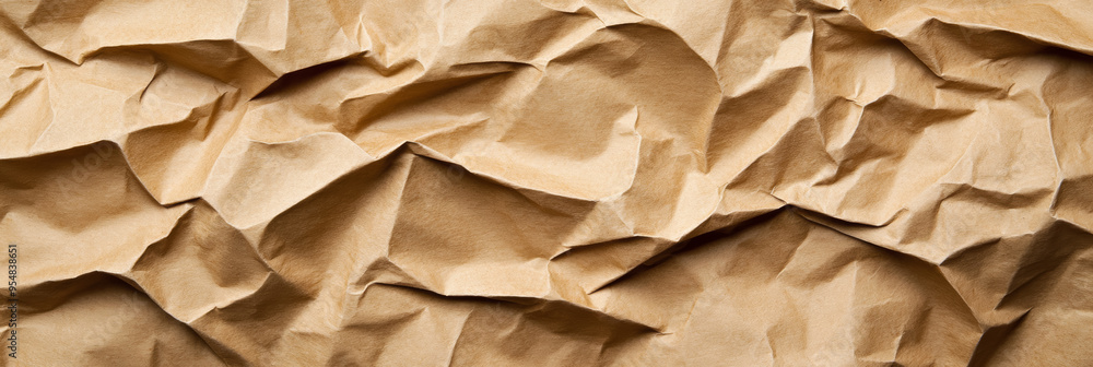 Poster crumpled recycled paper texture in natural brown tones with visible folds and shadows for a rustic f