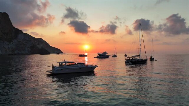 Risveglio all'alba nella baia dell'Arco Naturale dell'isola di Ponza, Italia, Mar Tirreno, Mediterraneo.
Le barche ancorate nella baia pi&ugrave; suggestiva di Italia in una mattina d'estate col sole giallo.