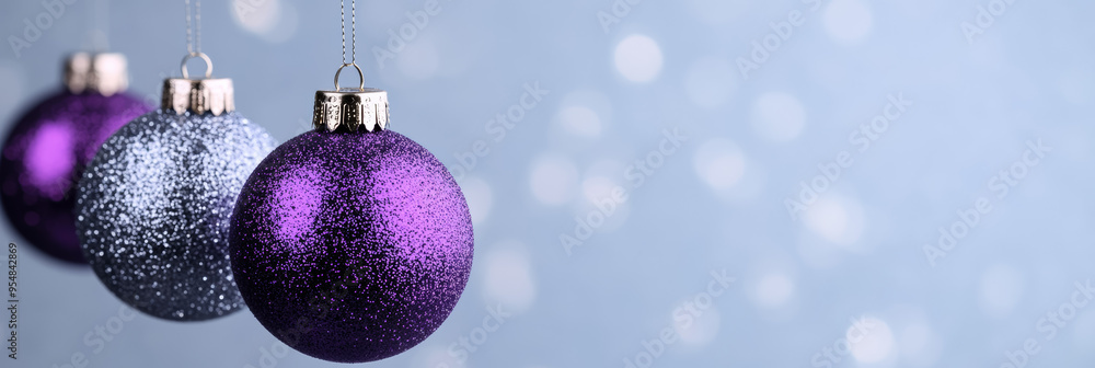 Canvas Prints Glittering purple and silver Christmas balls suspended in midair with a magical snowy out of focus background 