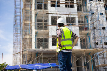 back view Engineering people, construction site. construction worker planning and architecture in construction site. Caucasian men