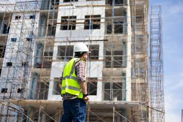 back view Engineering people, construction site. construction worker planning and architecture in construction site. Caucasian men