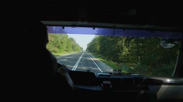 Through the windshield, you can see the road from the cab of the truck. High quality 4k footage