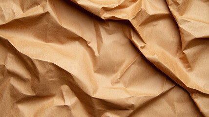 Scrunched up recycled paper background in natural brown tones deep wrinkles and folds creating texture 