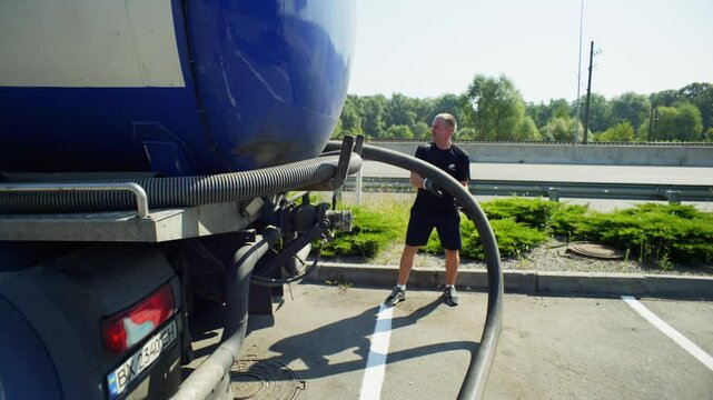 A man in gloves takes out a pipe from a sewer. Preparation for pumping out waste. High quality 4k footage