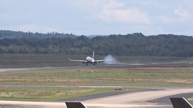 landing generic airplane visible touchdown smoke airport front view intensity aircraft makes contact airplane landing international airport aviation operations runway landing