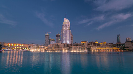 Fototapeta premium The Dancing Fountain of Dubai and lake day to night timelapse at dusk in Dubai, UAE.