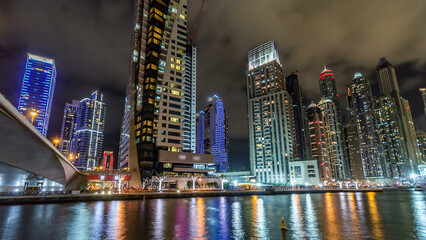 Naklejka premium Dubai Marina towers and canal in Dubai night timelapse hyperlapse
