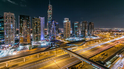 Fototapeta premium Buildings of Jumeirah Lakes Towers with traffic on the road night timelapse.