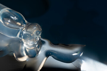 pipette with oil lies on a metal gua sha massager