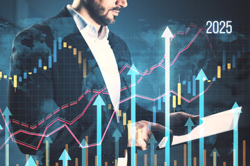 Side view of headless young businessman using tablet with growing business chart grid hologram and...