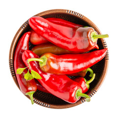 Red peppers in bowl isolated on white background. Top view, close-up. Long sweet pepper Ramiro.