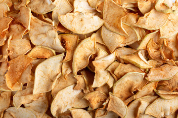 Homemade apple chips as background. Dried fruit. Healthy snack. Top view.