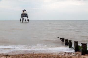 Lighthouse in the sea long exposure, Dovercourt lighthouse at high tide built in 1863 and discontinued in 1917 and restored in 1980 the lighthouse is still a iconic sight on a cloudy evening 