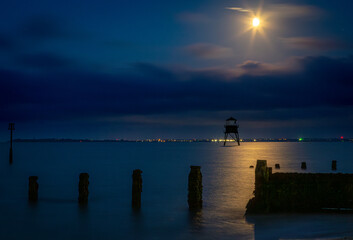 Dovercourt lighthouse at night, Image shows the historic lighthouse along Dovercourt beach illuminated by the moon on a late evening with long exposure