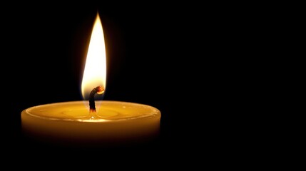 Single candle flame illuminating darkness, creating a warm atmosphere in a quiet room at night