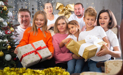 Portrait of happy family who is satisfied of presents in time celebration New Year in home