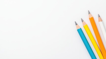 Fototapeta premium Colorful pencils arranged on a white background, perfect for artistic projects and educational materials.