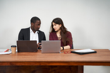 Multiethnic Colleagues Use Cellphones and Try Smartphone Applications In Office