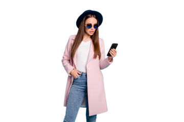 Portrait of astonished woman use her cellphone read news wonder say its omg wear pink coat outfit stylish denim jeans eyewear eyeglasses isolated over blue color background