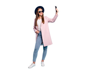 Full size photo of content lovely girl using her cell phone taking selfie wearing pink outfit denim jeans eyewear eyeglasses isolated over blue background