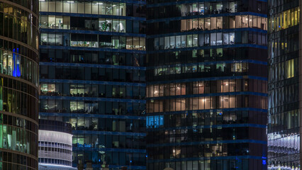 Close up view to office windows in Skyscrapers of City at night timelapse from top