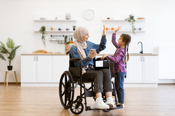 Happy family moment showcasing inclusivity, technology use, and positive parenting Muslim mother in...