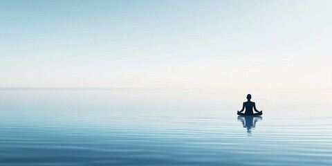 Person Meditating in Lotus Position on Calm Water Surface
