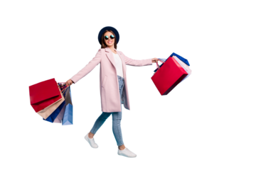 Full length photo of lovely cheerful lady in eyeglasses eyewear have rest go shopping buy souvenirs wear topcoat denim jeans isolated over blue background