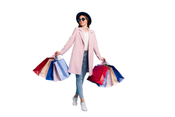 Full length photo of lovely content girl on holiday buy presents for friends wear retro topcoat eyewear eyeglasses denim jeans isolated over pink background