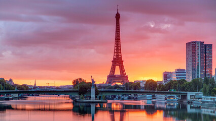 Eiffel Tower sunrise timelapse with boats on Seine river and in Paris, France.