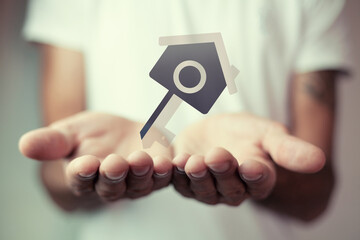 man holds house in palm, property insurance