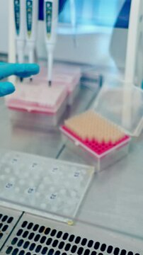 Medical equipment blood test in laboratory. Female technician analyzing blood sample in medical laboratory. Vertical video