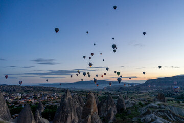 Hot air balloons rise before the sun rises