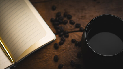 Notepad, Pen, and Coffee Beans in a Cup on a Wooden Surface