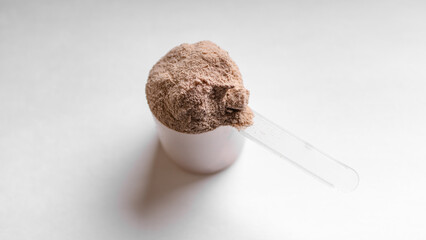 Scoop of Whey Protein Powder on a White Background