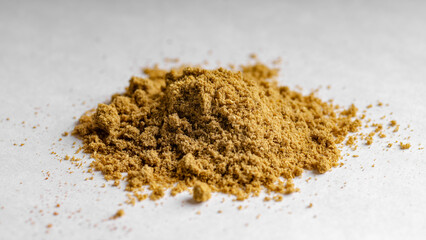 Grounded coriander seeds on a white background.