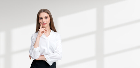 Businesswoman with finger on chin, thinking on copy space white background