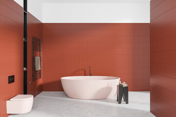 Tiled home bathroom interior with tub, wall hung toilet and accessories