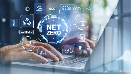Net zero concept with holographic icons on a laptop screen promoting green energy and eco-friendly practices.