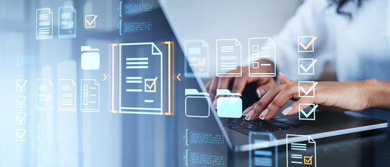 Hands typing on laptop with digital document icons overlay.
