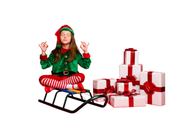 Portrait of her she nice attractive calm peaceful focused pre-teen elf Santa Claus look outfit sitting on sled lotus pose position wish want isolated over bright vivid shine red background
